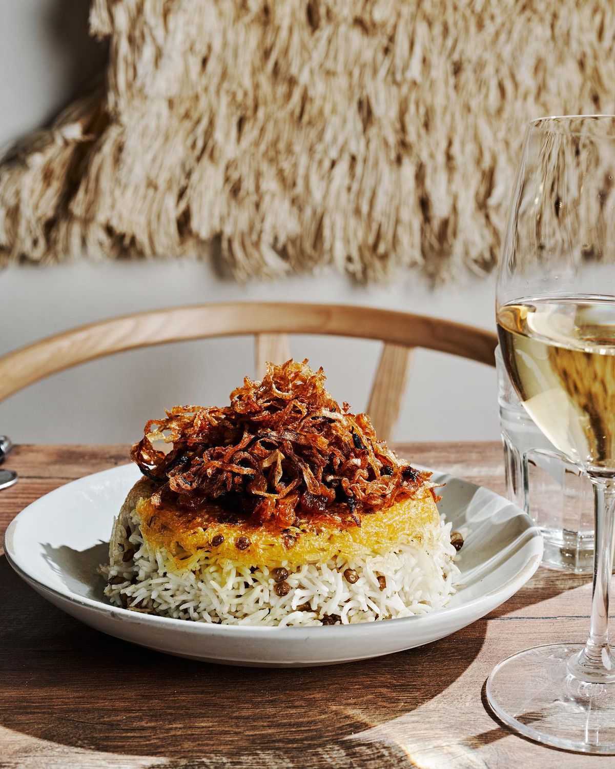 Adas polo, a traditional Persian lentil rice dish made with a rice crust called tahdig from Delbar in Atlanta.