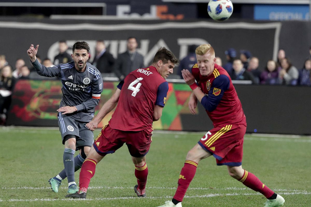 New York City forward David Villa (7) tries to score but misses as he shoots over Real Salt Lake defender David Horst (4) and defender Justen Glad (15) during the second half of an MLS soccer game, Wednesday, April 11, 2018, in New York. NYCFC won 4-0. (A