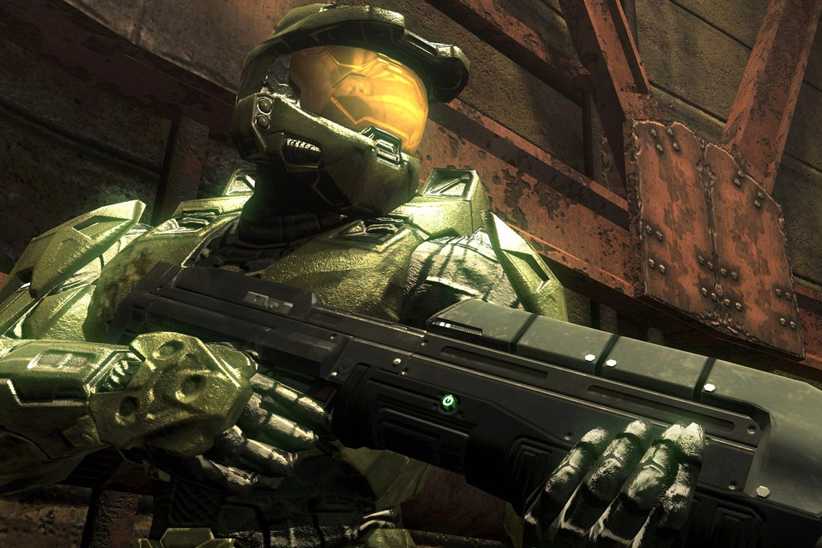 A close up of Master Chief in Halo: Combat Evolved. He is looking to the right and holding a large fun.