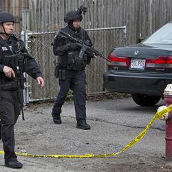 Police continue to patrol the neighborhoods of Watertown, Mass. Friday, April 19, 2013, as a massive search continued for one of two suspects in the Boston Marathon bombing. A second suspect died in the early morning hours after an encounter with law enforcement. (AP Photo/Craig Ruttle)