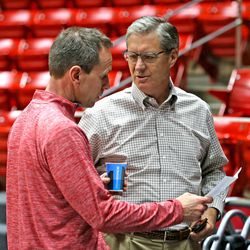 FILE - Utah Athletic Director Chris Hill and  assistant coach Tommy Connor talk for a moment after the University of Utah's men's basketball practice at the Jon M. Huntsman Center before heading off to play Duke University in the Sweet 16 in Houston, Monday, March 23, 2015, in Salt Lake City.