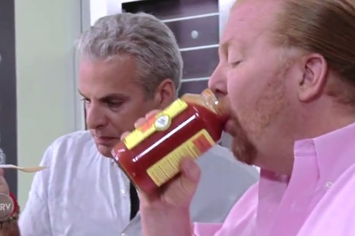 Just a good photo of Mario Batali drinking his branded tomato sauce straight from the jar.