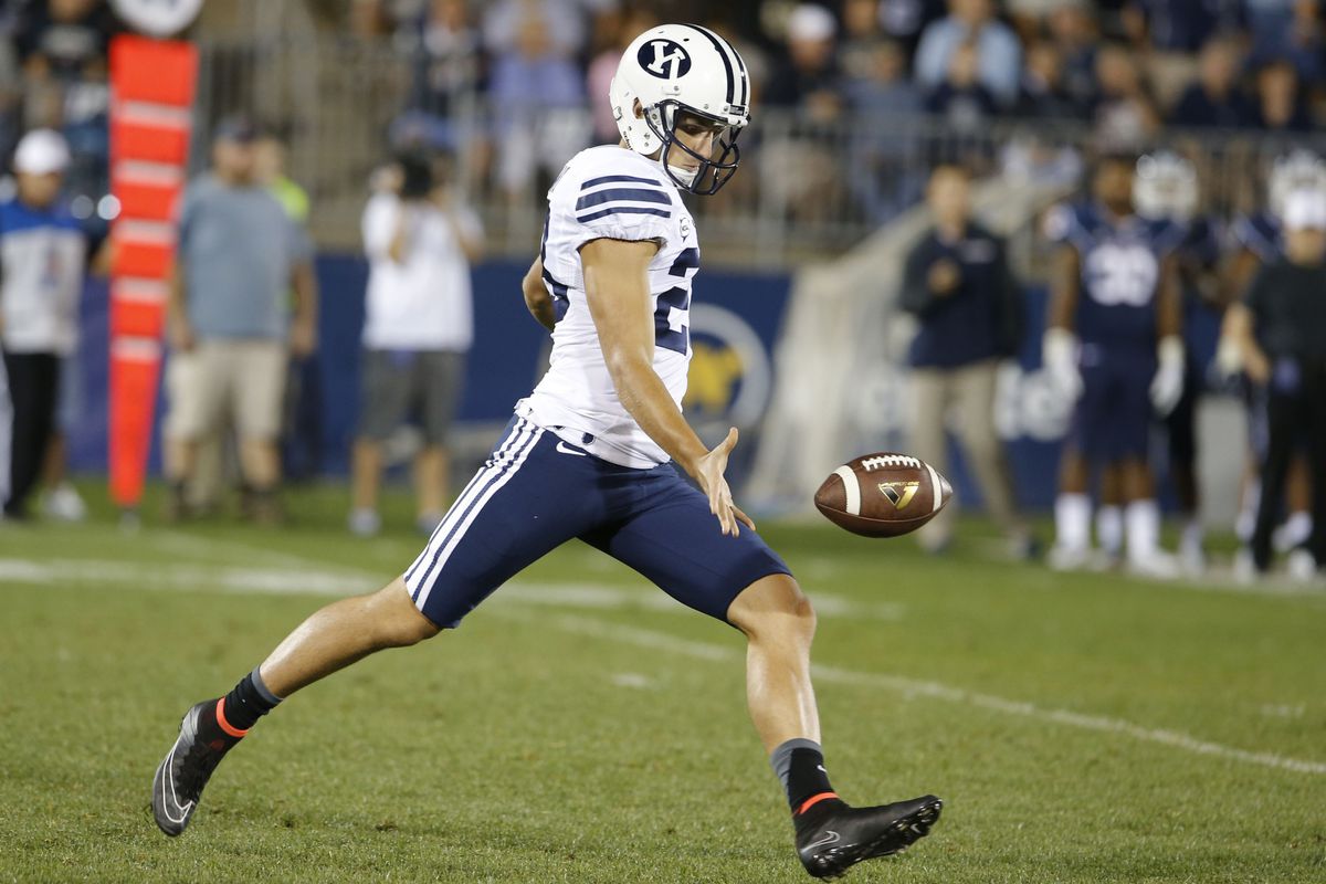 Scott Arellano (23) punts the ball against the Connecticut Huskies during the second half.
