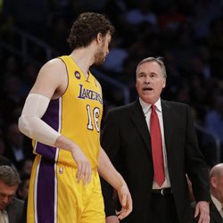 Los Angeles Lakers' Mike D'Antoni, right, talks to Pau Gasol, of Spain, during the first half of an NBA basketball game against the Houston Rockets in Los Angeles, Wednesday, April 17, 2013. (AP Photo/Jae C. Hong)