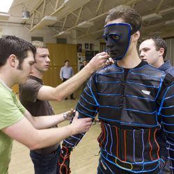In this 2012 file photo, BYU engineering students team up with the ballroom dance team to create light suits to be worn during a dance performance.