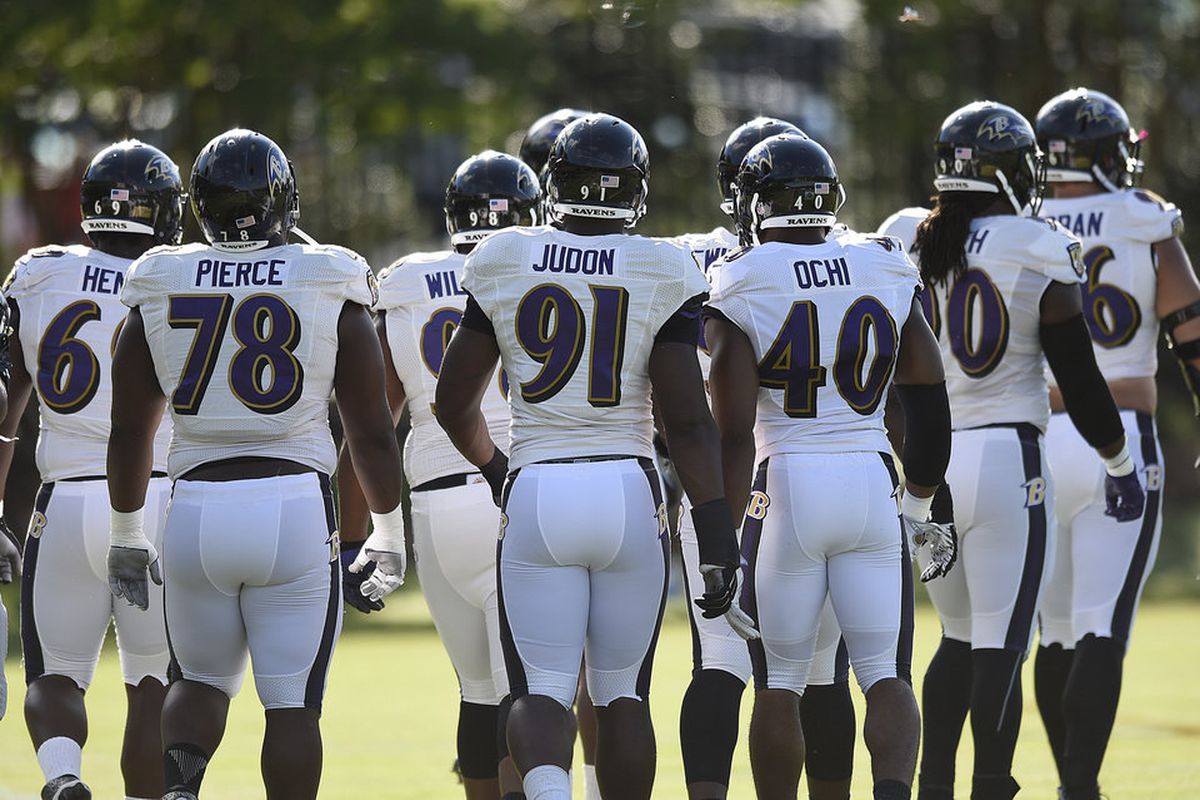 Baltimore Ravens defensive players, including left to right, Michael Pierce, Matthew Judon and Victor Ochi, line up for a drill during NFL football training camp in Owings Mills, Md., Thursday, Aug. 4, 2016. (AP Photo/Gail Burton)