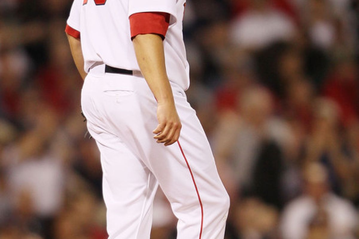 BOSTON - APRIL 04:  Josh Beckett #19 of the Boston Red Sox reacts after giving up a home run to Jorge Posada of the New York Yankees on April 4, 2010 during Opening Night at Fenway Park in Boston, Massachusetts.  (Photo by Elsa/Getty Images)