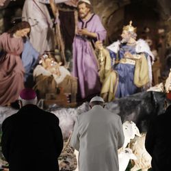 Pope Francis prays in front of the nativity scene after celebrating a new year's eve vespers Mass in St. Peter's Basilica at the Vatican, Saturday, Dec. 31, 2016. 