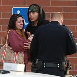 The parents of 3-year-old Bella Martinez talk to police Wednesday, Feb. 4, 2015, after the girl was kidnapped when the car she was in was stolen from a 7-Eleven store at 287 W. 3300 South in South Salt Lake. The girl was later found safe and the woman who allegedly took the car was arrested.