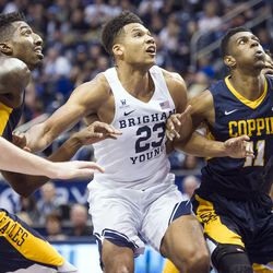 Brigham Young forward Yoeli Childs (23) fights for position with Coppin State forward Izais Hicks (11) during an NCAA college basketball game in Provo on Thursday, Nov. 17, 2016.