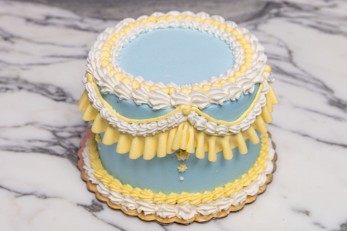 A blue, white, and yellow frosted cake.