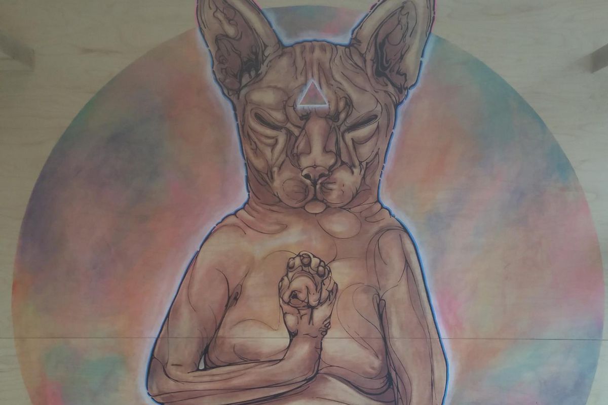 Meditating cat mural at KitTea