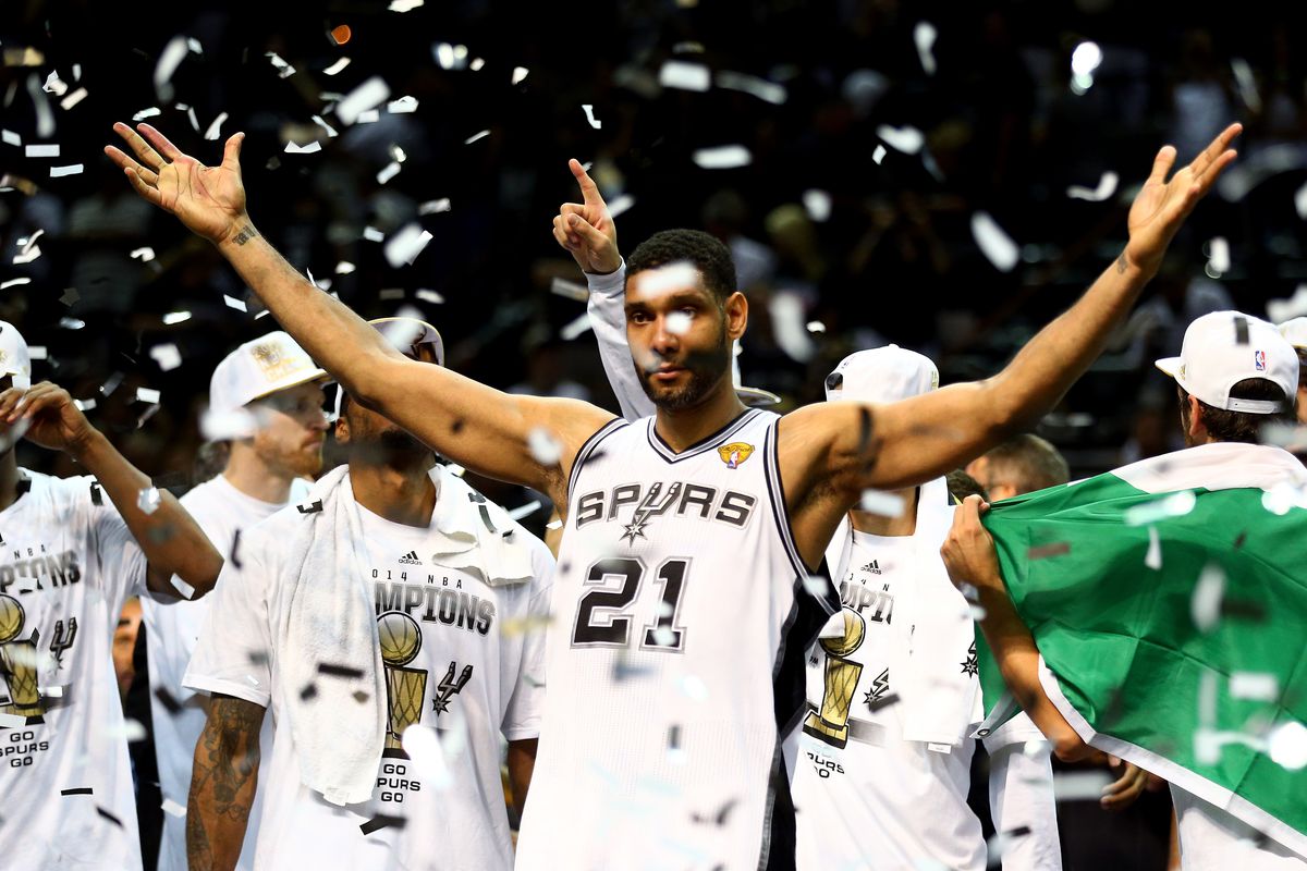 Tim Duncan puts his hands up in celebration following the Spurs finals clinching game against the Heat