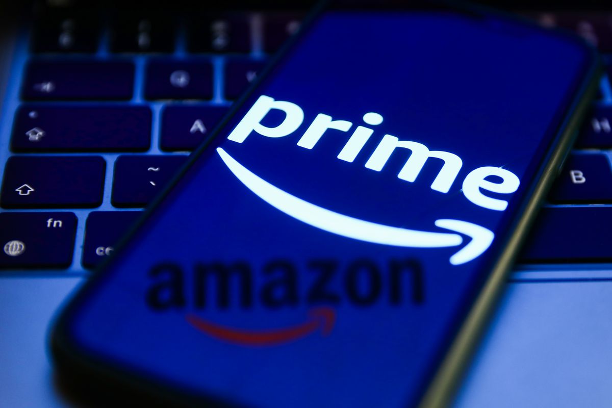 Amazon Prime logo displayed on a phone screen, Amazon logo reflected on a screen and laptop keyboard are seen in this illustration photo taken in Krakow, Poland on July 26, 2022.
