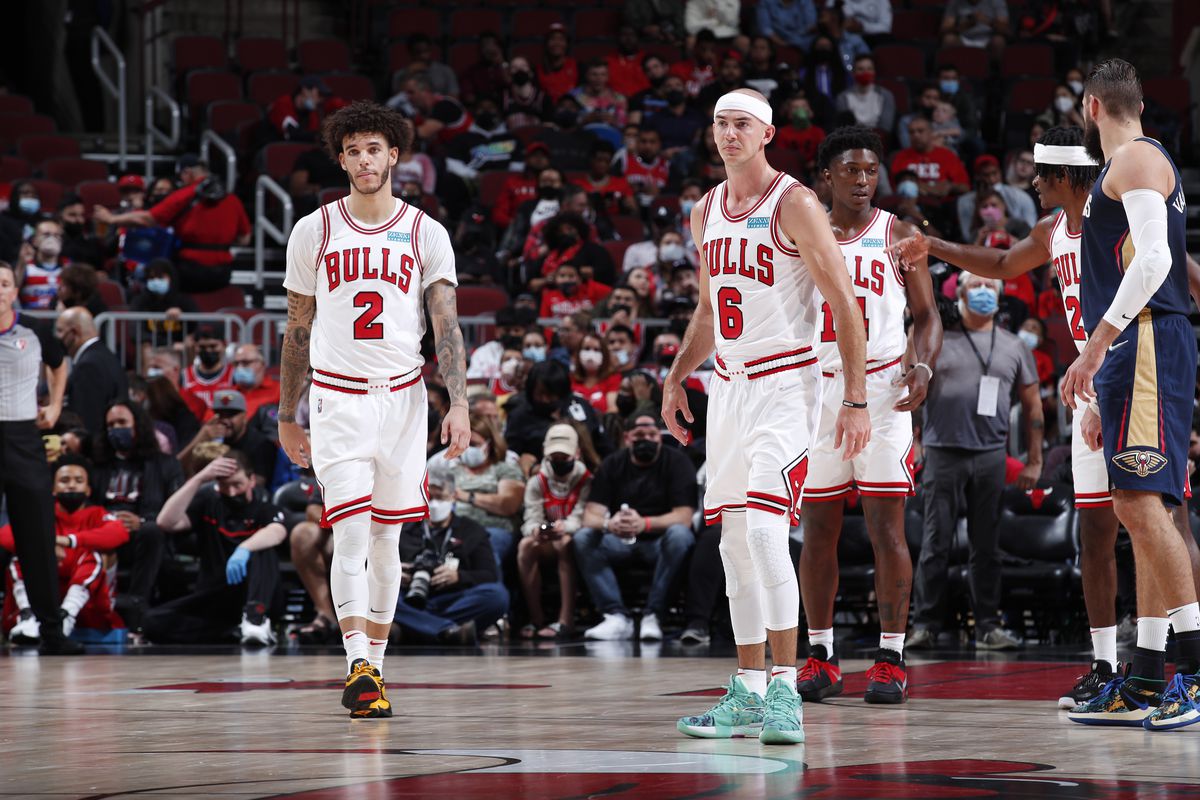 Lonzo Ball #2 and Alex Caruso #6 of the Chicago Bulls looks on during a preseason game against the New Orleans Pelicans on October 8, 2021 at United Center in Chicago, Illinois.