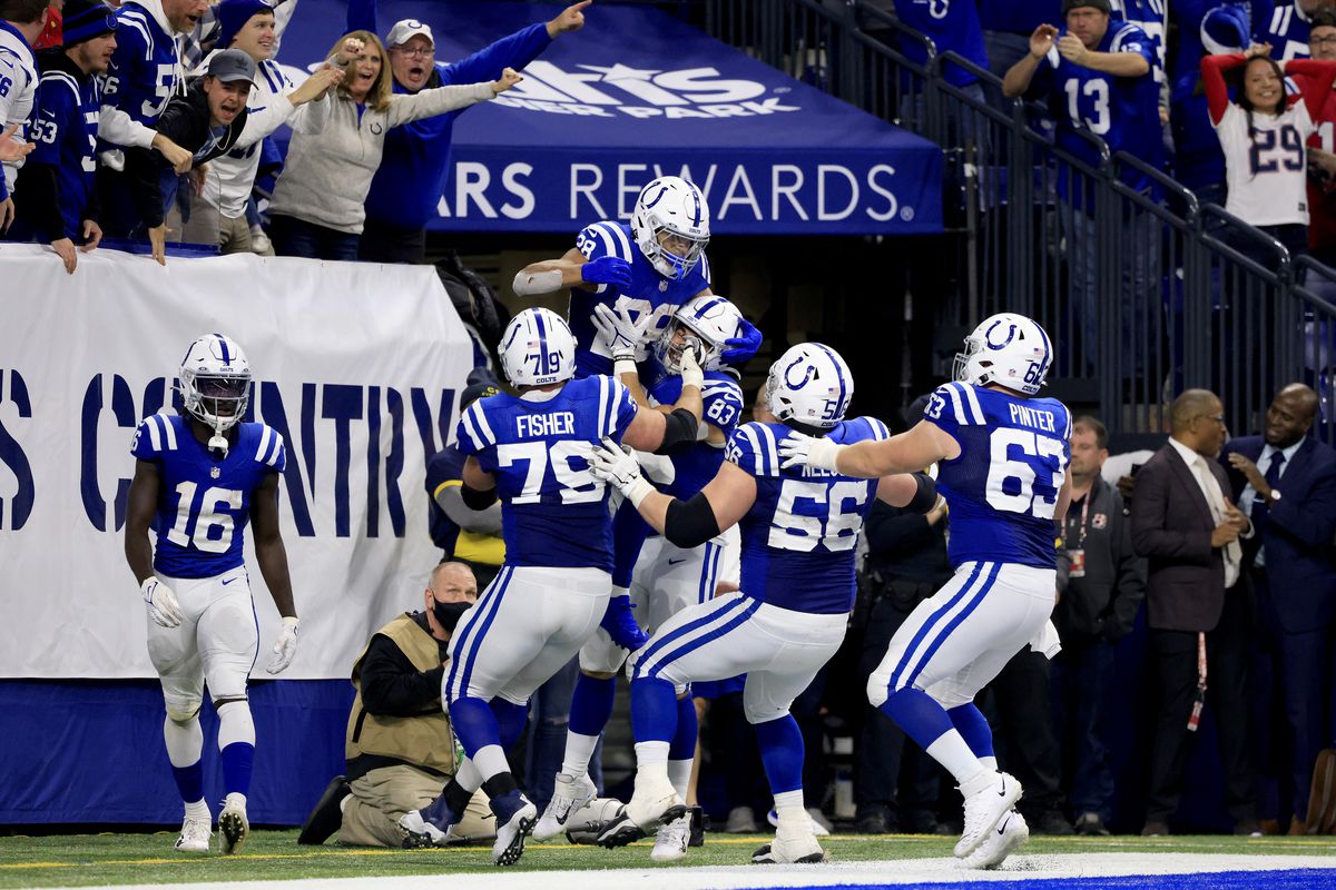 Jonathan Taylor #28 of the Indianapolis Colts celebrates his touchdown with teammates during the fourth quarter against the New England Patriots at Lucas Oil Stadium on December 18, 2021 in Indianapolis, Indiana.