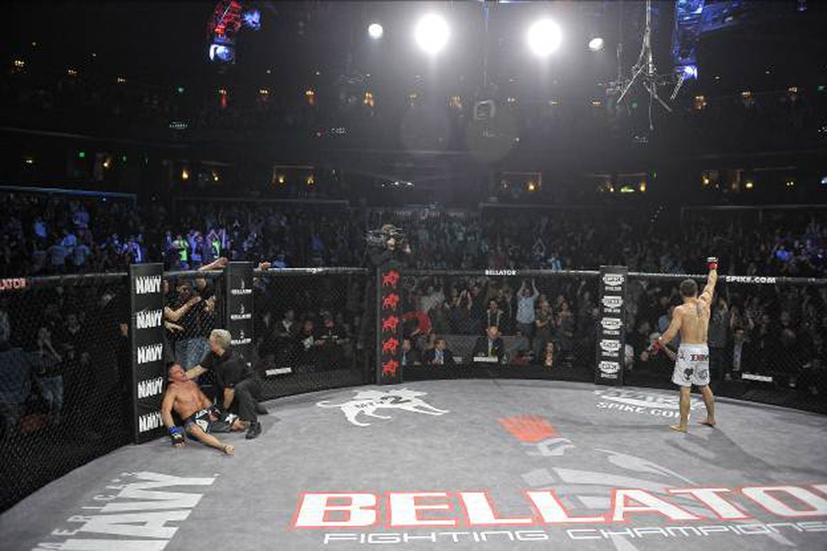Pat Curran (right) celebrates after viciously knocking out Joe Warren (left) to claim the Bellator featherweight title last night at Bellator 60 in Hammond, Indiana. Photo credit via Bellator.