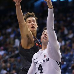 Brigham Young Cougars guard Nick Emery (4) flips the ball up under Brigham Young - Hawaii forward Denhym Brooke (10) as BYU and BYU-Hawaii play in preseason action at the Marriott Center in Provo on Wednesday, Nov. 9, 2016.