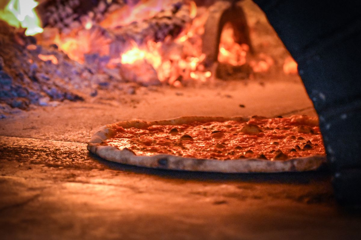 A pizza cooking in the restaurant’s wood-fired Italian oven at La Parolaccia.