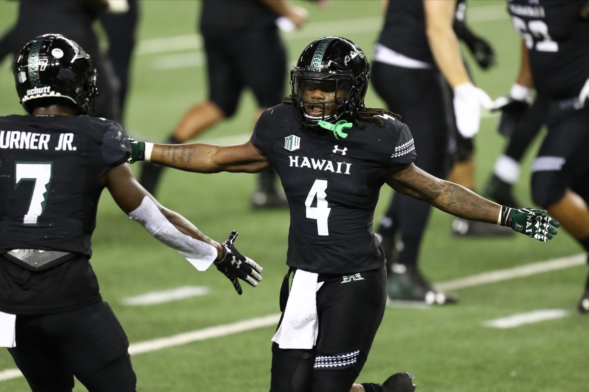 Miles Reed of the Hawaii Rainbow Warriors celebrates with Calvin Turner after scoring a touchdown during the third quarter against the Nevada Wolf Pack at Aloha Stadium on November 28, 2020 in Honolulu, Hawaii.