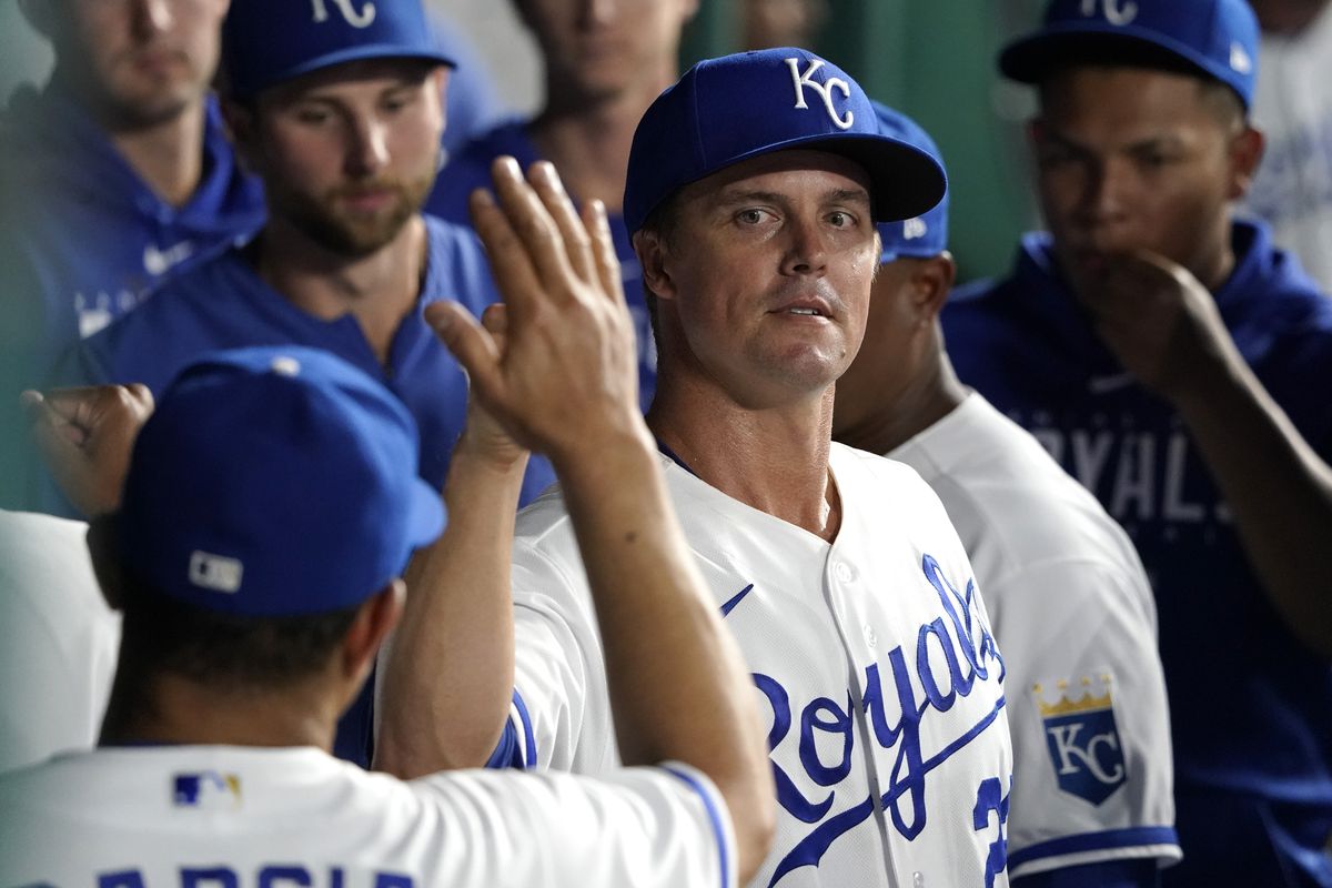 Zack Greinke #23 of the Kansas City Royals high-fives teammates in the dugout after exiting a game in the fifth inning against the Pittsburgh Pirates at Kauffman Stadium on August 28, 2023 in Kansas City, Missouri.