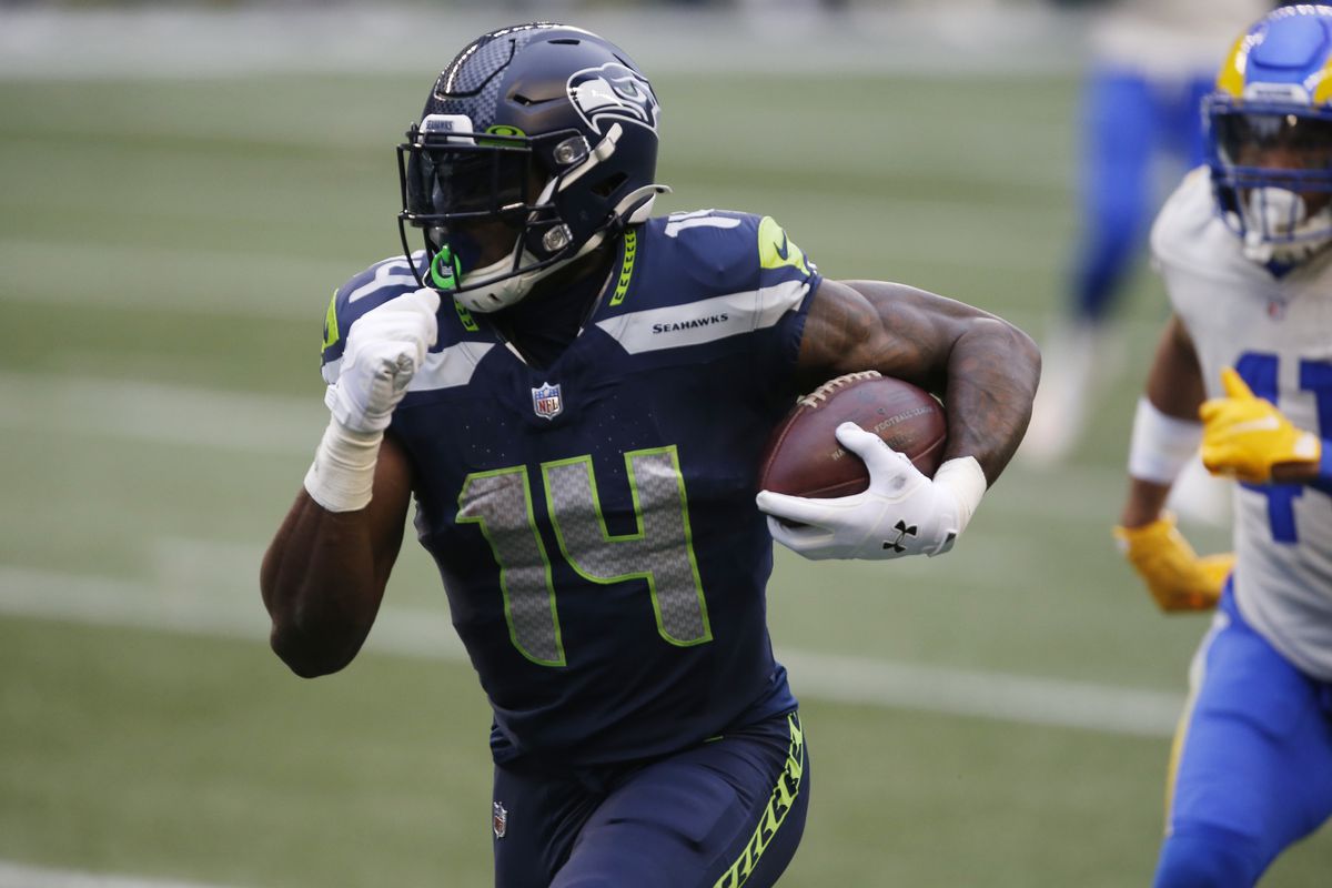 Seattle Seahawks wide receiver DK Metcalf (14) runs after a catch for a touchdown against the Los Angeles Rams during the second quarter at Lumen Field.