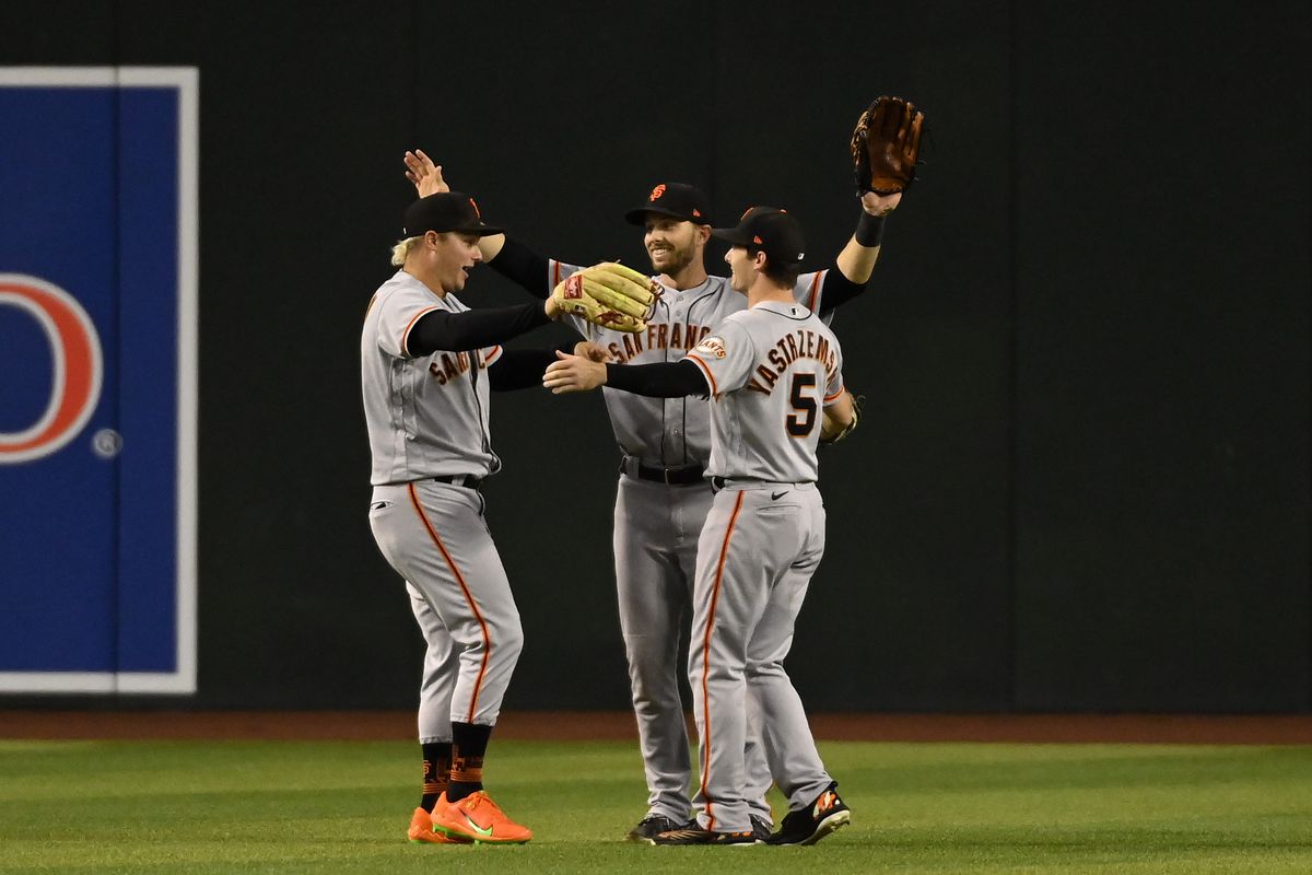 Giants outfielders celebrating after winning