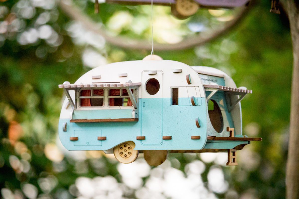 Mini camper birdhouse hanging in a tree