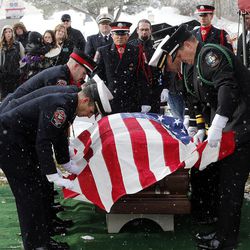 An honor guard folds a flag during graveside services for Jake Shepherd in Mendon on Monday, Nov. 28, 2016. Shepherd was one of three crew members of a medical aircraft that crashed just after takeoff on Nov. 18 while transporting a patient from Elko, Nevada, to University Hospital in Salt Lake City. All four people died in the crash.