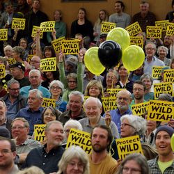 Several hundred Utahns hold up their signs as they gather at the University of Utah to voice their opinions of the proposed Public Lands Initiative Wednesday, March 2, 2016. 