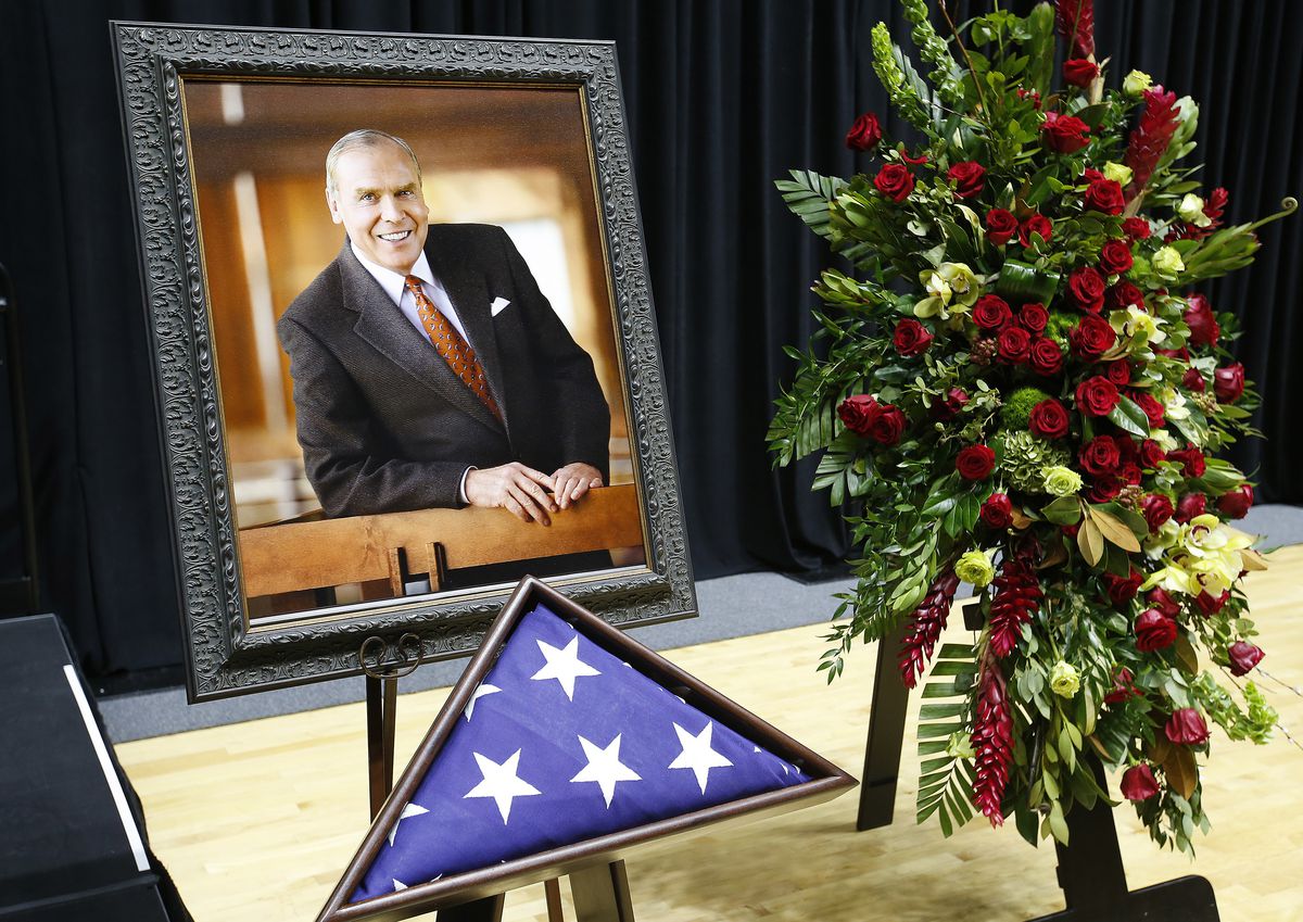 A photo of Jon M. Huntsman Sr. is surrounded by flowers and and an American flag during his funeral in the Huntsman Center at the University of Utah in Salt Lake City on Saturday, Feb. 10, 2018.