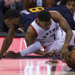 Toronto guard Kyle Lowry (7) and Utah guard Shelvin Mack (8) battle for possession of the ball during an NBA basketball game in Salt Lake City on Friday, Dec. 23, 2016. Toronto took down Utah with a final score of 104-98.