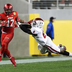 Utah Utes wide receiver Demari Simpkins (17) stiff-arms Indiana Hoosiers linebacker Tegray Scales (8) as the Utes and the Hoosiers play in the Foster Farms Bowl in Santa Clara, California, on Wednesday, Dec. 28, 2016.