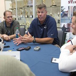 BYU Offensive Line Coach Garrett Tujague meets with member of the media during the 2013 BYU Football Media Day.