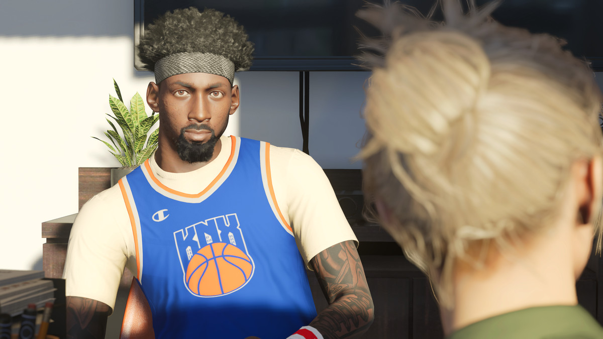 The NBA 2K23 created player, wearing a Knicks Gaming tank top and a snakeskin headband, sits in bright morning light in an office talking to one of his managers, who is in the foreground