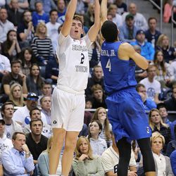 Brigham Young Cougars guard Zac Seljaas (2) drains a 3-pointer over Creighton Bluejays guard Ronnie Harrell Jr. (4) as BYU and Creighton play in NIT quarterfinal action at the Marriott Center in Provo Tuesday, March 22, 2016.