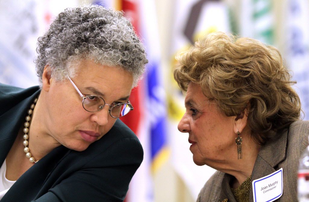 Cook County Board President Toni Preckwinkle (left) and Commissioner Joan Murphy whisper to each other while mayors speak at the South Suburban Mayors and Managers Association at 1904 W. 174th Street in East Hazel Crest in January 25, 2011. | Joseph P. Me