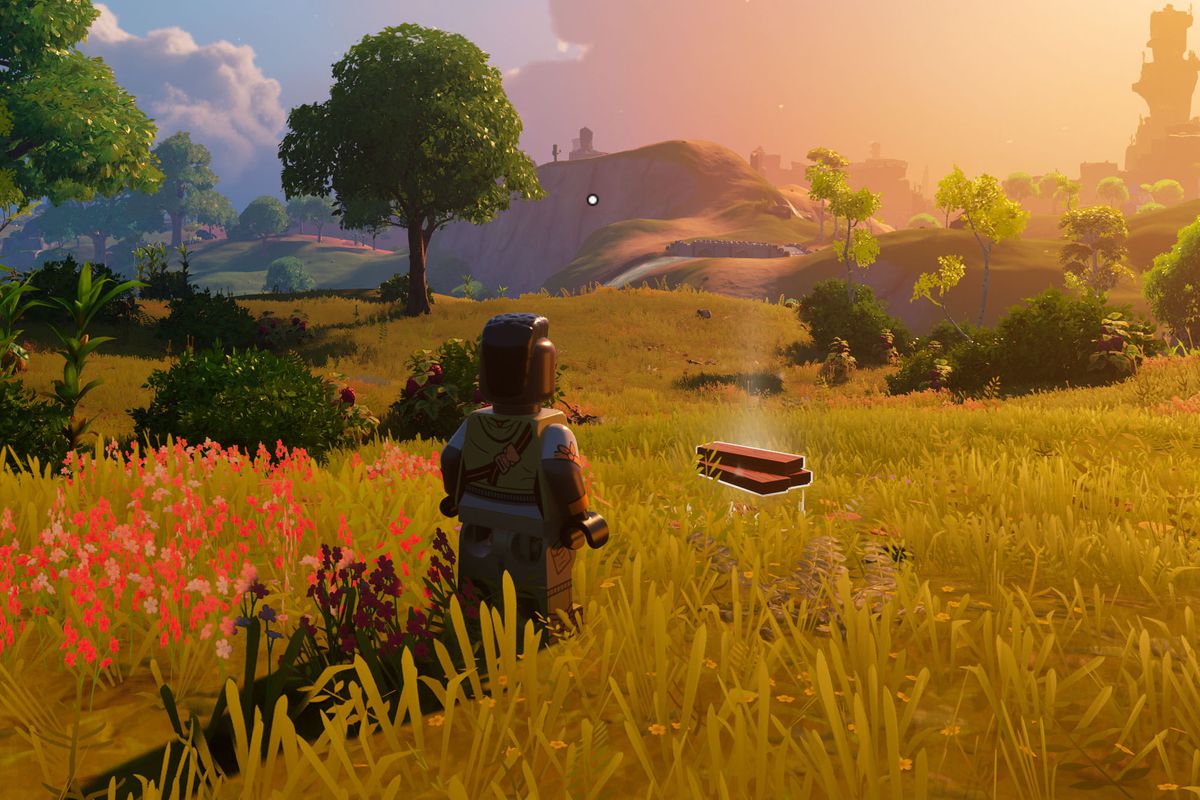 A Lego person stands next to planks in a field at sunset in Lego Fortnite.
