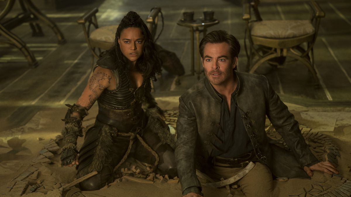 Michelle Rodriguez and Chris Pine look surprised while kneeling on the floor in Dungeons &amp; Dragons: Honor Among Thieves.