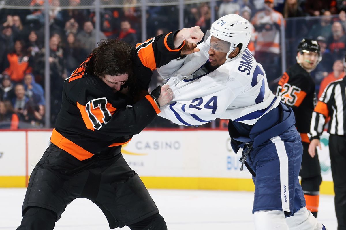 Zack MacEwen throws a punch at Wayne Simmonds with his left hand while gripping Simmonds’ jersey with his right