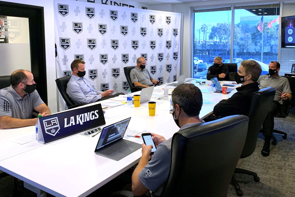 President Luc Robitaille, general manager Rob Blake, head coach Todd McLellan and Los Angeles Kings team personnel sit at their draft table during the first round of the 2020 NHL Entry Draft at the Toyota Sports Performance Center on October 06, 2020 in El Segundo, California. The 2020 NHL Draft was held virtually due to the ongoing Coronavirus pandemic.