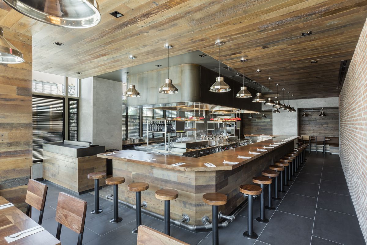 Interior look of the wood-paneled pasta bar Uovo in Los Angeles.