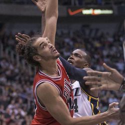 Utah's Paul Millsap pushes up a shot with Chicago's Joakim Noah as the Jazz and the Bulls play Friday, Feb. 8, 2013 at Energy Solutions arena.