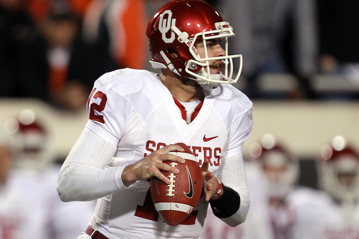 STILLWATER, OK - DECEMBER 03:  Landry Jones #12 of the Oklahoma Sooners throws against the Oklahoma State Cowboys at Boone Pickens Stadium on December 3, 2011 in Stillwater, Oklahoma.  (Photo by Ronald Martinez/Getty Images)