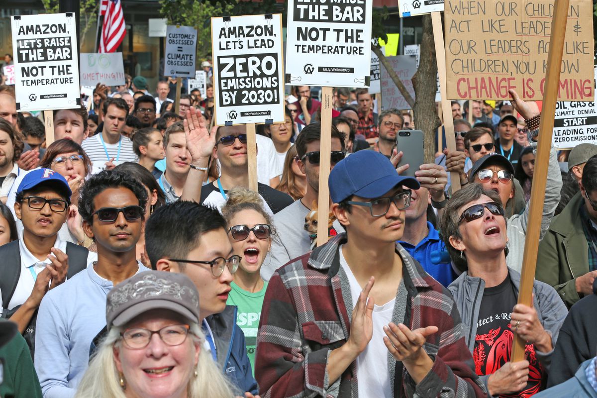 A crowd of Amazon employees holding signs about climate change participate in a global climate strike.