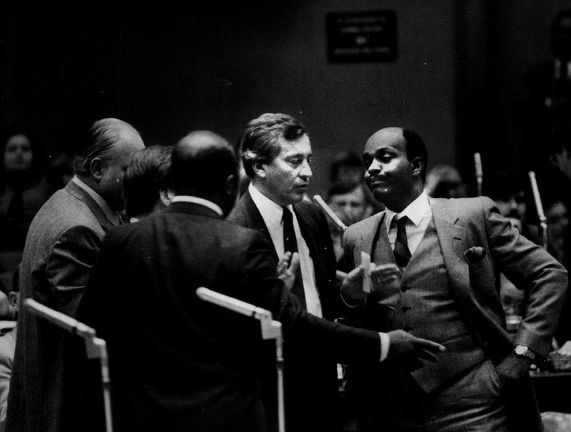 Ald. Perry H. Hutchinson, right, talks with Ald. Edward R. Vrdolyak and other aldermen in 1985. Sun-Times File Photo.