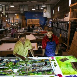 Tom Holdman, left, and Nick Lawyer, right, discuss the progress of an art glass panel that will be part of “The Roots of Knowledge,” a 200-foot-long stained glass installation for Utah Valley University, at Holdman Studios in Lehi on Friday, Nov. 4, 2016. The university announced a $1.5 million donation from philanthropists Marc and Deborah Bingham that will enable the completion of the massive stained glass installation.