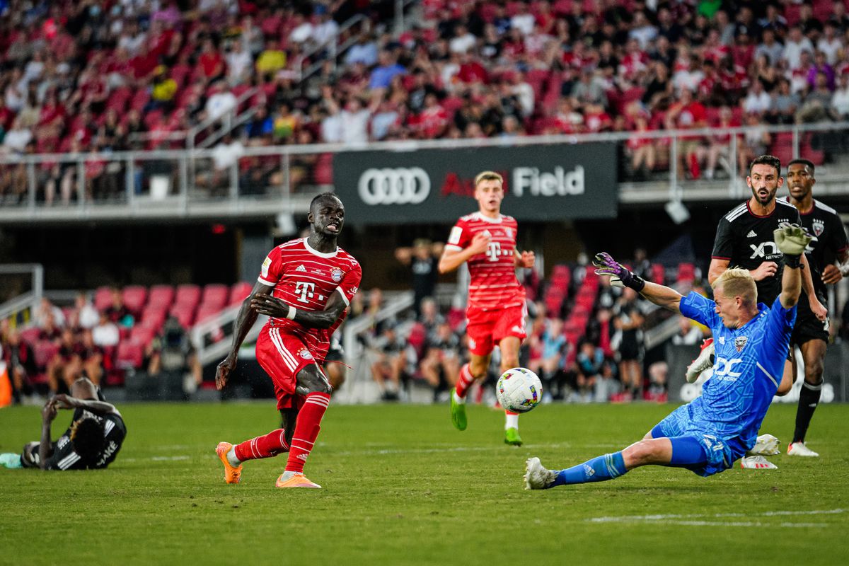 Sadio Mané watches his shot as the DC United goalkeeper stretches to save it.