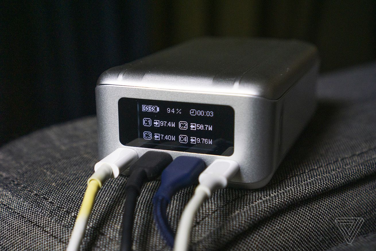 A close-up of the Zendure SuperTank Pro’s built-in OLED, showing charge output levels for the four USB-C devices plugged into its ports below the screen.
