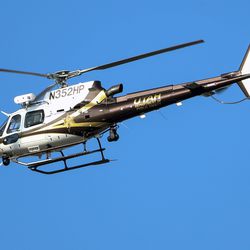A Utah Department of Public Safety helicopter flies over neighborhoods to the east of Fashion Place Mall following a shooting art the mall in Murray on Sunday, Jan. 13, 2019.